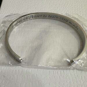 Brand new. Silver “it Takes a Big Heart to Teach Little Minds” cuff bracelet